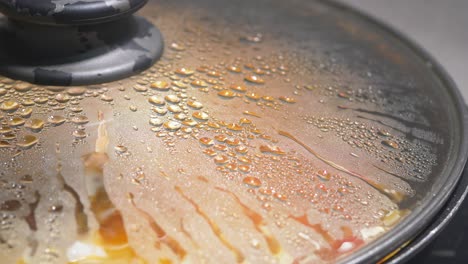 close-up of a cooking pot with lid and condensation