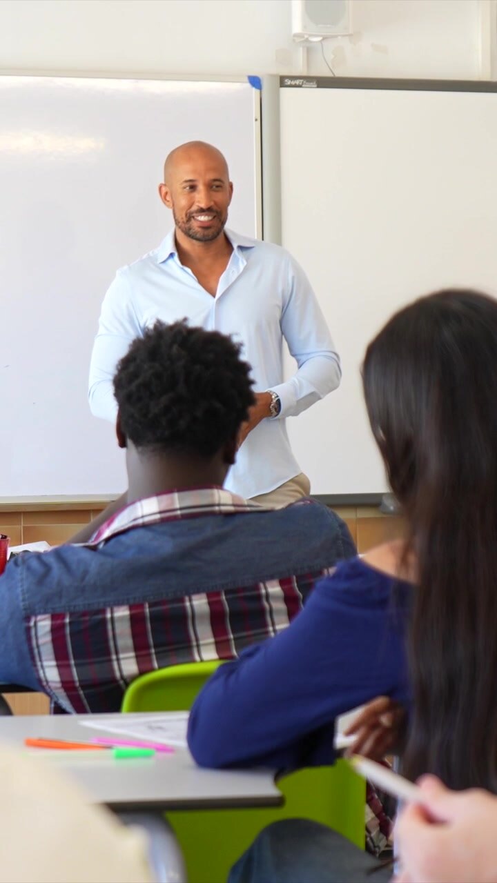 Male Teacher Giving a Presentation to Students in a Classroom