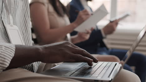 unrecognizable person typing on laptop computer