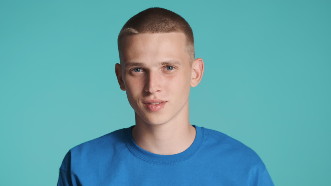 파란 티셔츠를 입은 젊은이가 침을 요청합니다.