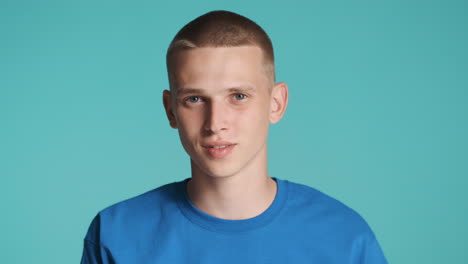 Young-man-in-blue-T-Shirt-asking-for-silence