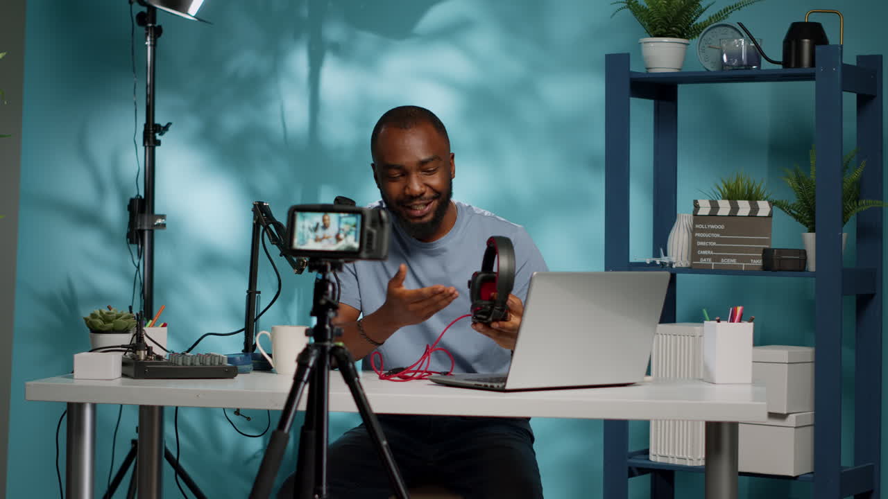 Content creator holding headphones for product review