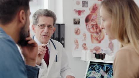 handheld view of gynecologist consulting prognosis with young couple