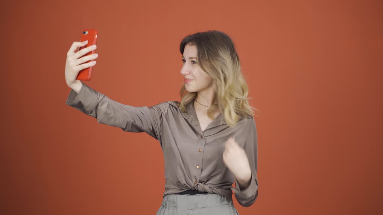 Young woman making a video call on the phone.
