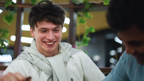 white boy eyes wide mouth open screaming wow reacting to friend drawing scene captured spontaneous expression youthful excitement vivid emotion bright. during creative sketch session on smartphone camera