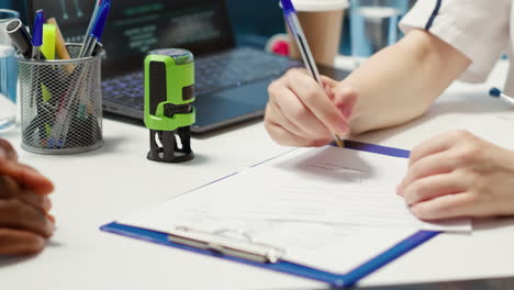 skilled physician creating a prescription with her stamp for validity