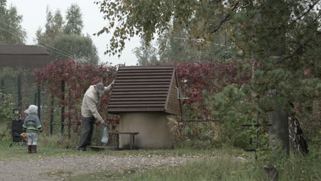 Grandfather-and-grandson-near-well