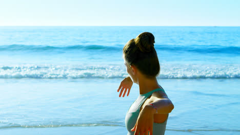 Woman-performing-yoga-in-the-beach-4k