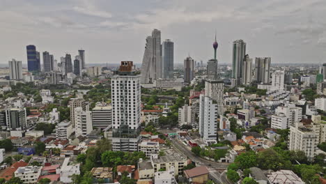 Colombo-Sri-Lanka-Aerial-v19-drone-flyover-Kollupitiya-capturing-Gangaramaya-park,-lotus-tower-standing-at-Beira-lake-and-downtown-cityscape-of-the-capital-city---Shot-with-Mavic-3-Cine---April-2023