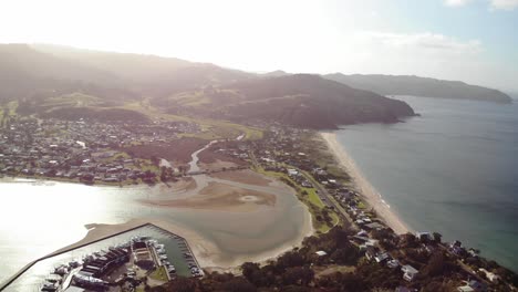 Aerial-View-of-Tairua-Beach-and-Lagoon,-Coromandel-Peninsula-Bay,-New-Zealand-on-Sunny-Evening,-Drone-Shot