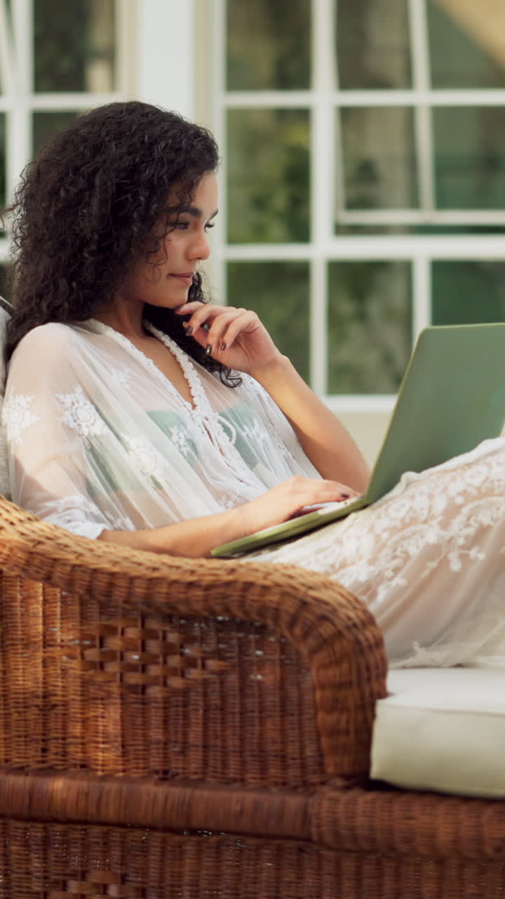 Young Woman Working on Laptop in a Relaxed Indoor Setting