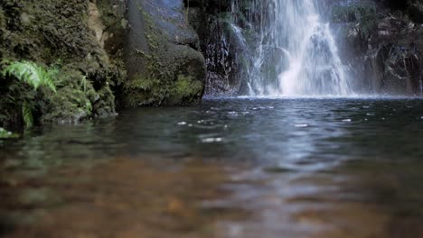 waterfall falling in to natural, mountain pool in madeira island