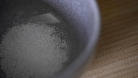 4k macro close up of salt grains in a small dish