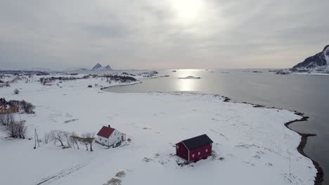 revealing norwegian traditional farm nice winter scenery landscape, backward aerial drone shot