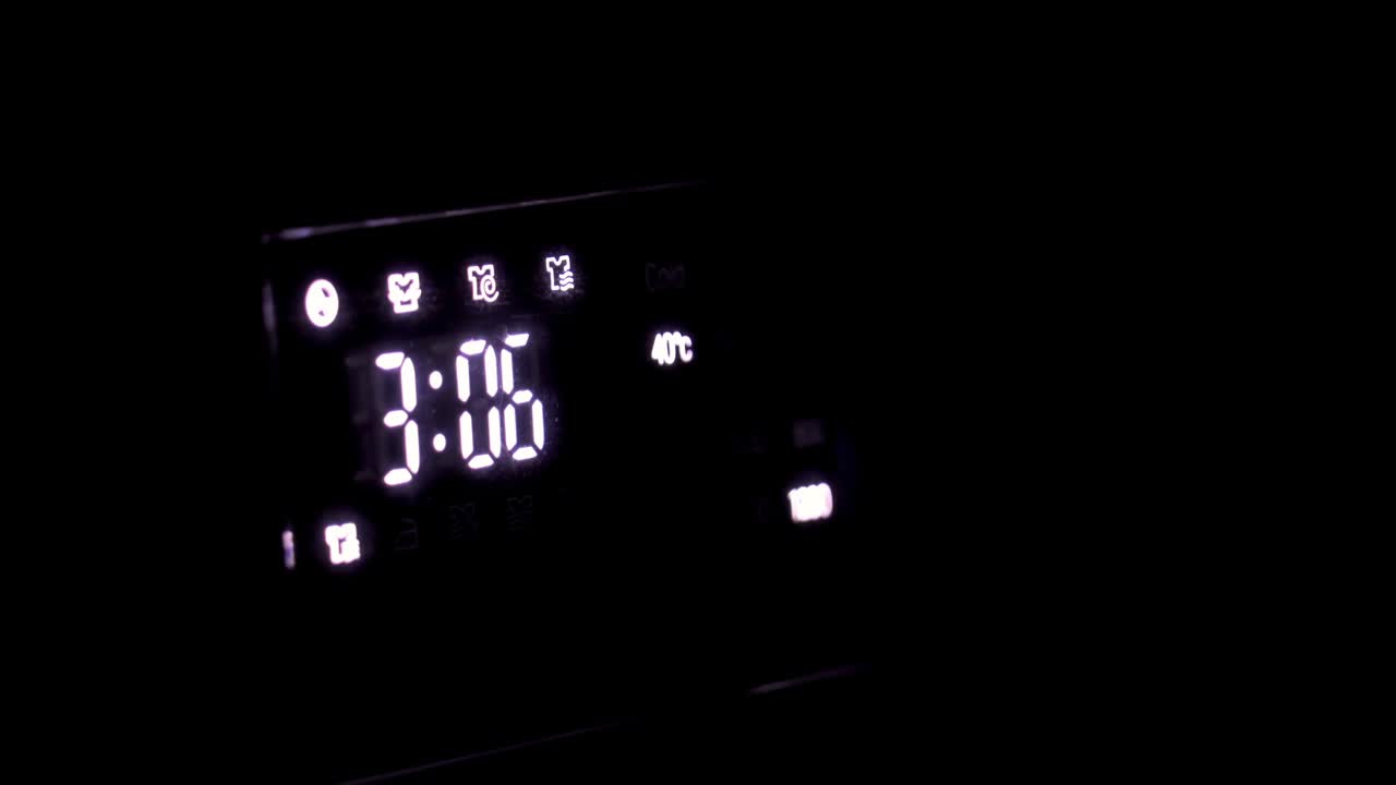 White digital clock on the black radio