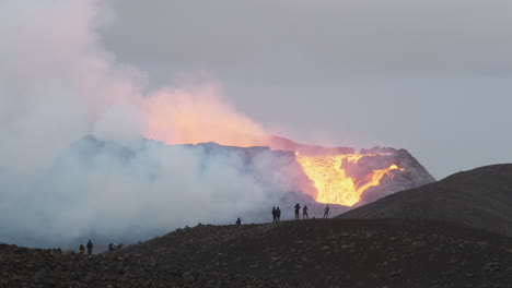 tourists watching iceland's newest active volcano geldingadalur erupt