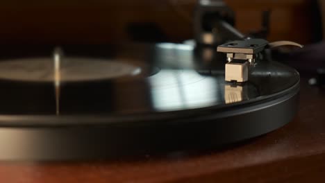 detail of a turntable needle with platter spinning, slow motion 4k