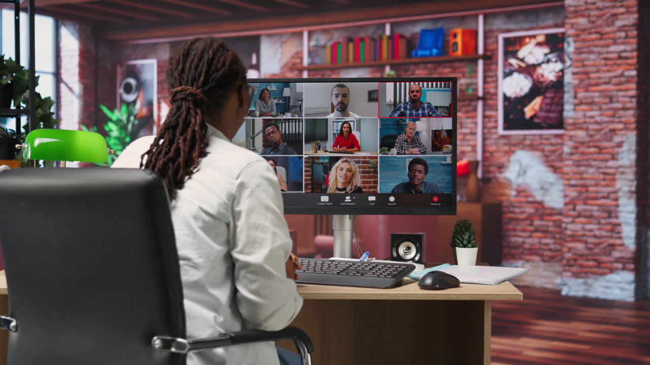 Remote employee in home office saluting colleagues during online videocall