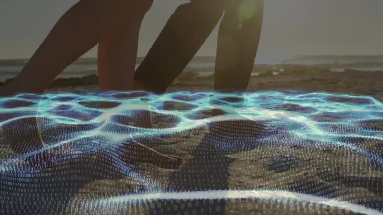 Couple walking on shore, stepping into blue mesh revealing footprints for technology demo