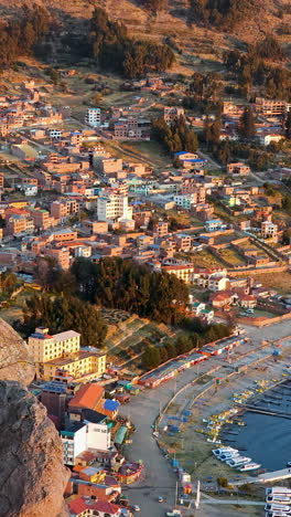 experience a stunning vertical aerial view of copacabana, bolivia, as seen from the top of cerro calvario