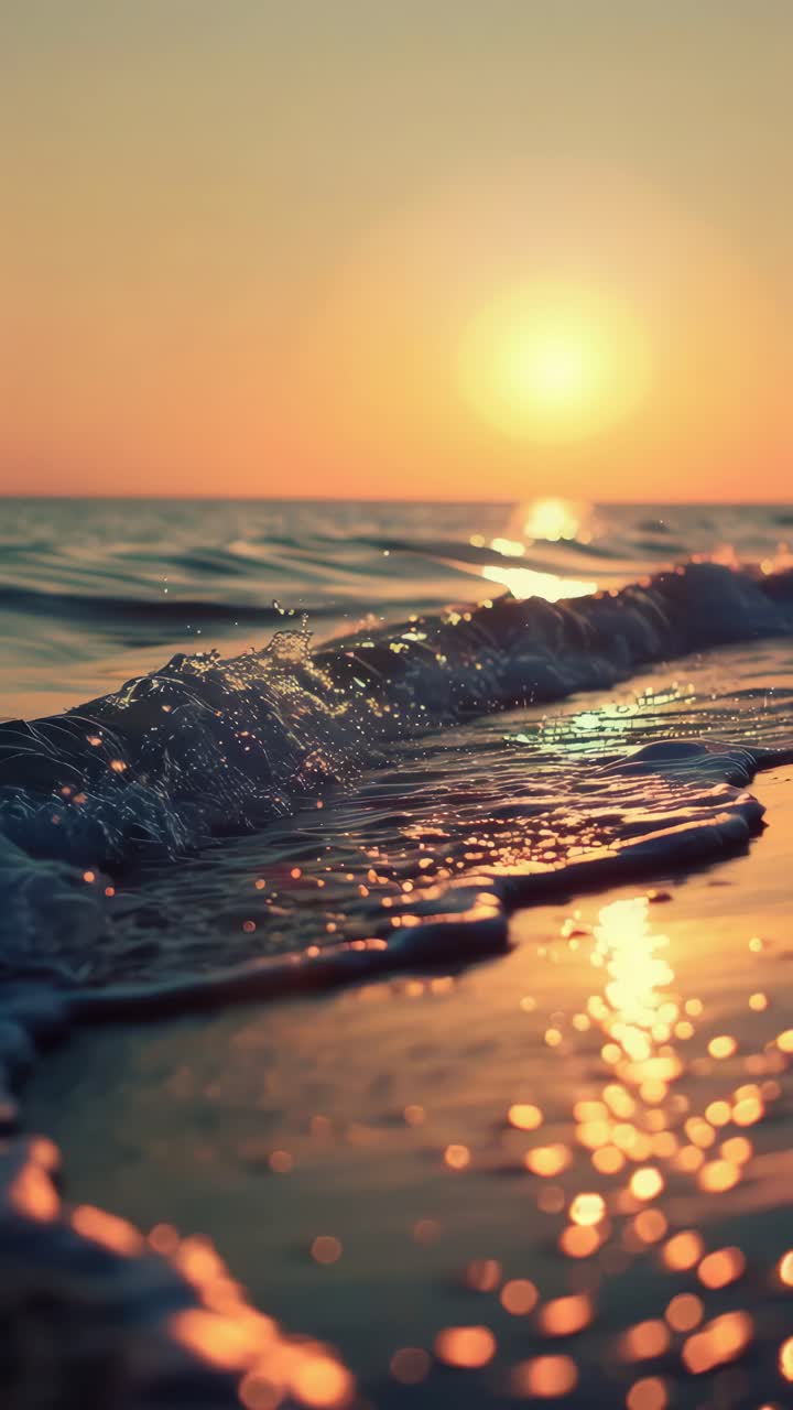 A serene sunset over gentle waves, captured at a low angle. The golden hues create a calming