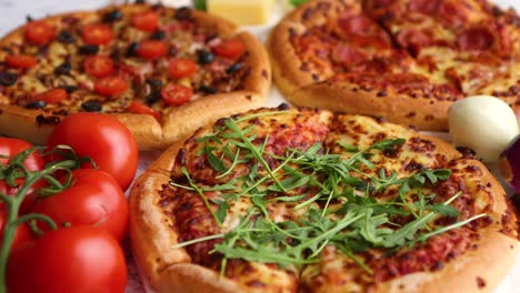 Three-american-style-pizzas-served-on-a-table