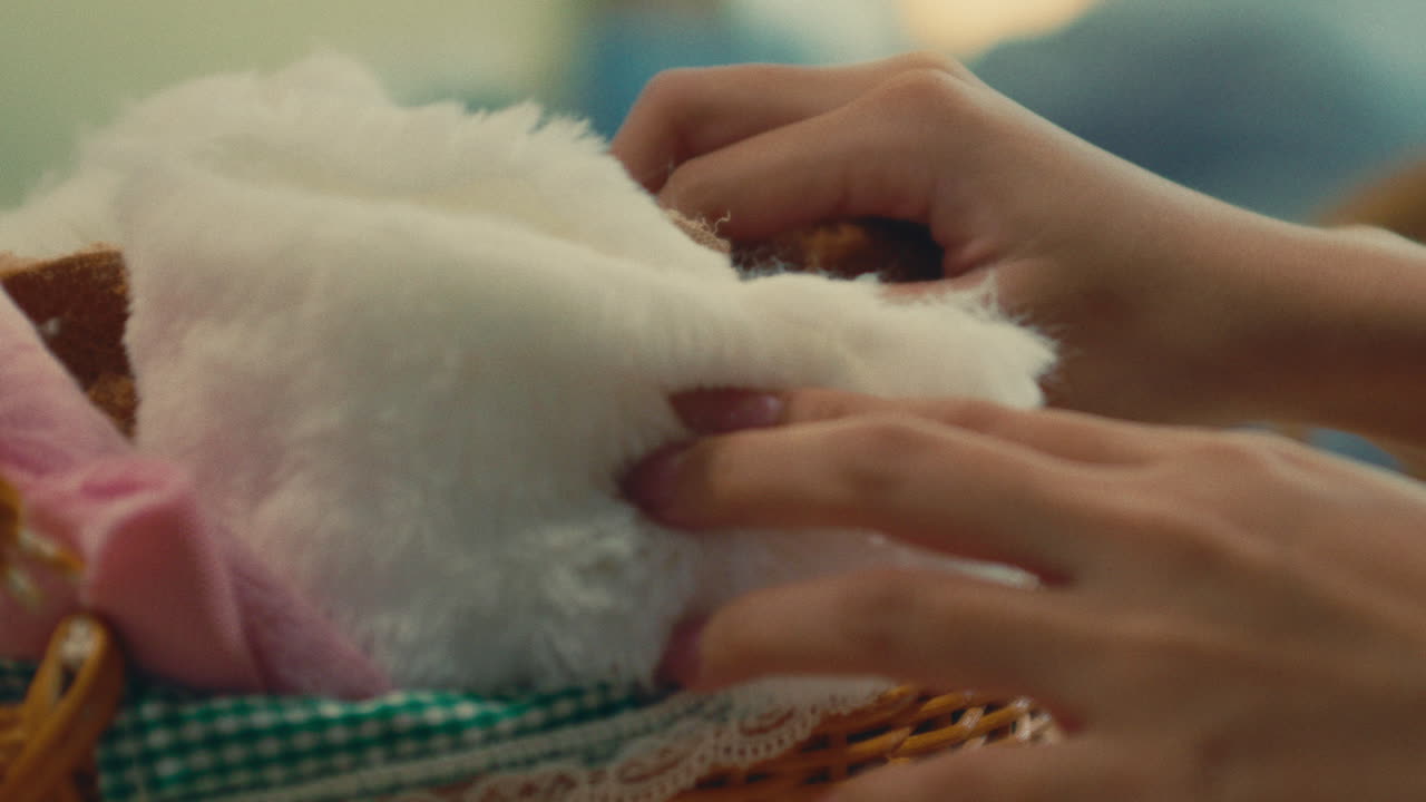 Child playing with teddy bear in a basket