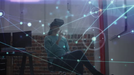 Animation of network of connections over biracial businesswoman wearing vr headset