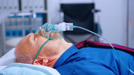 portrait of old male patient weating oxygen mask