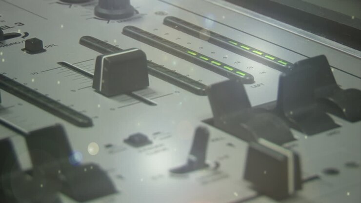 Digital composite of a DJ mixer and colorful particles