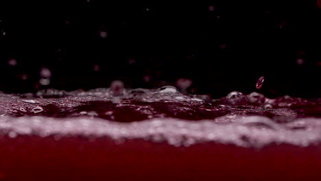 Rotes-Blut-Wie-Flüssiges-Spritzen-Und-Blasen-In-Zeitlupe-Im-Dunklen-Tank