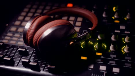 close-up of headphones on professional recording studio control panel