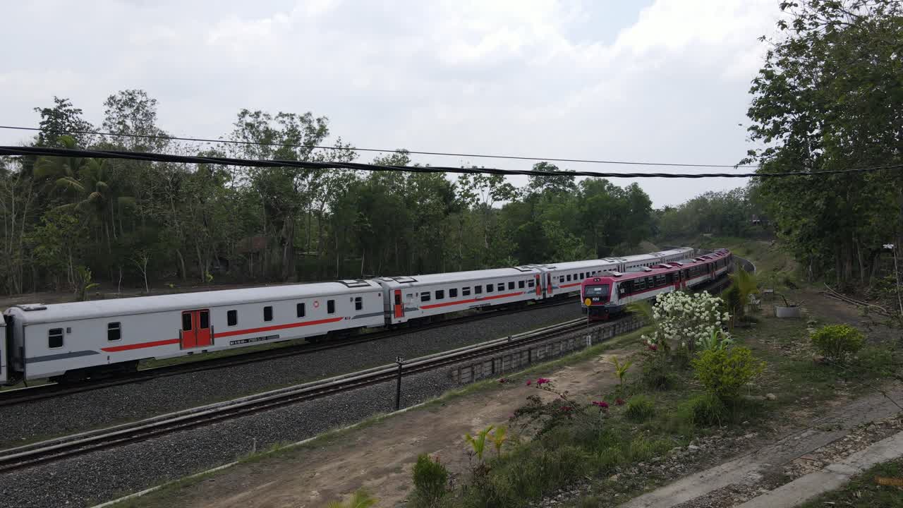 Indonesian trains run simultaneously on double-track railway tracks