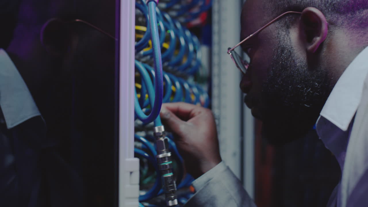 African American Technician Checking Server Cables