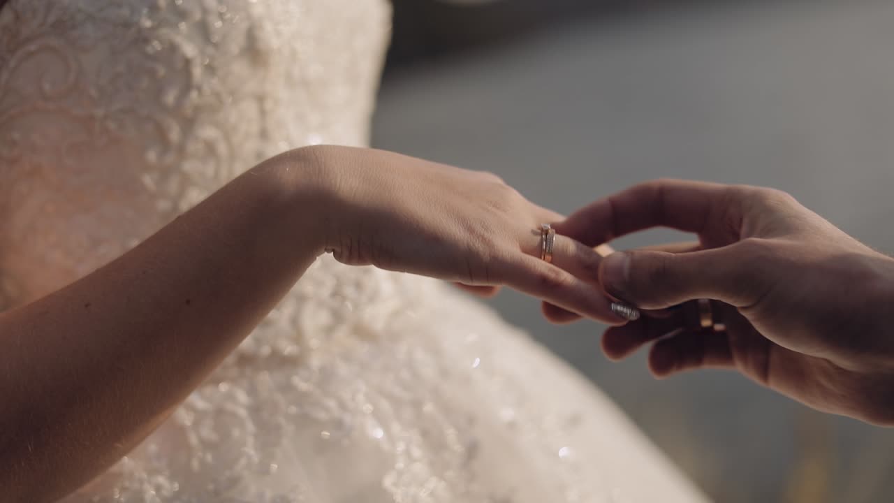 Groom puts on the bride's finger an engagement ring. Wedding couple