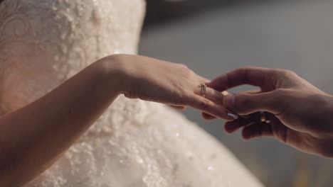 groom puts on the bride's finger an engagement ring. wedding couple