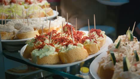 Assorted-Canapés-on-Venetian-Table,-food-shop-close-up