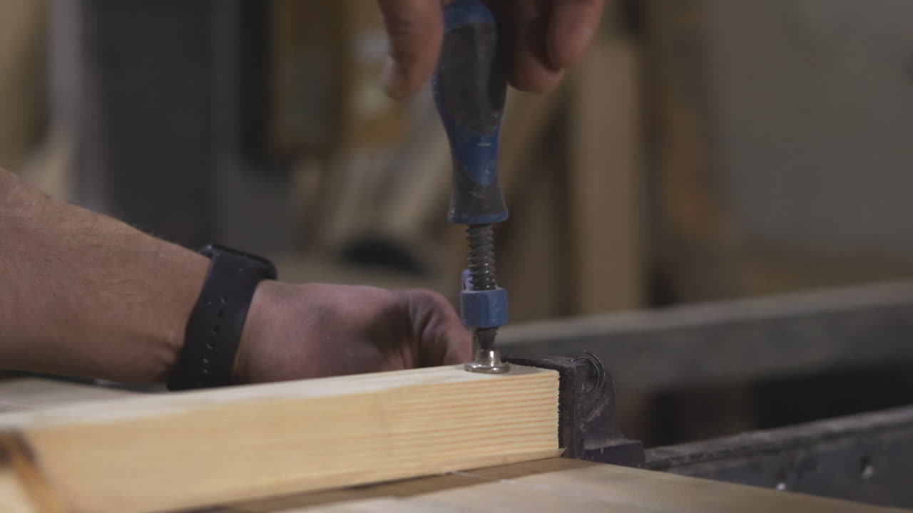 Using a clamp to secure wood