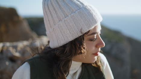 closeup carefree tourist relaxing ocean cliff edge. happy girl enjoy traveling