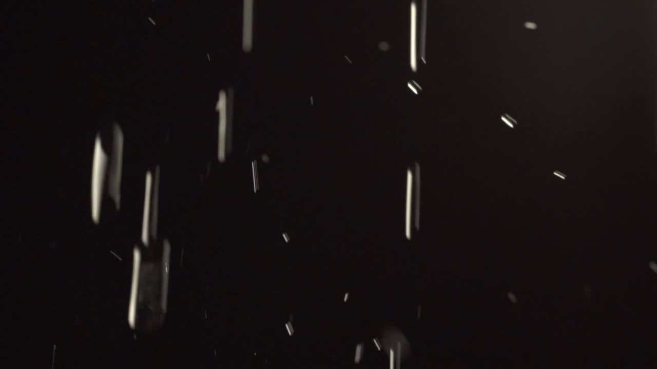 Water falling in slow motion before a black background