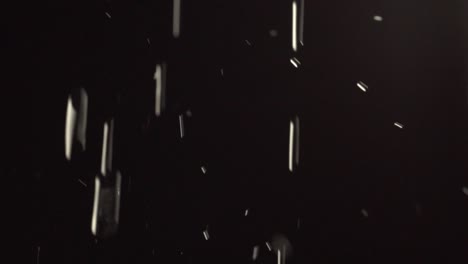 water falling in slow motion before a black background