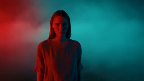 young woman in neon lit smoky environment