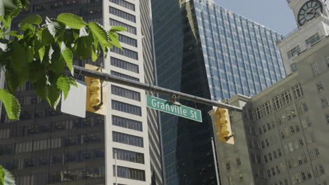 granville street crossing in vancouver, street sign with buildings in the background, handheld parallax