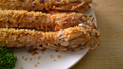 stir fried mantis shrimp with garlic on white plate