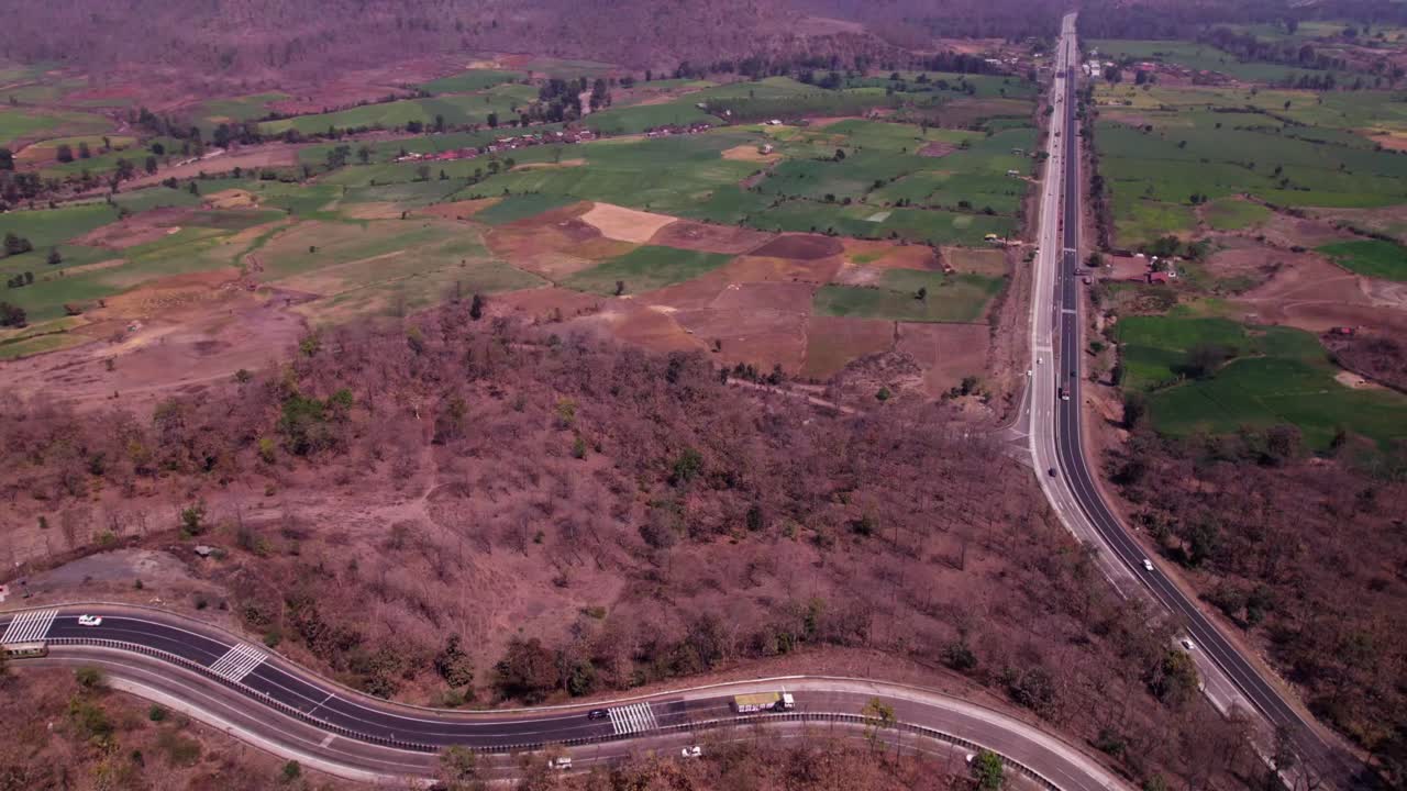 National highway 34 with farming land and Hill mountainous at day time, push back, tilt reveal shot, drone shot, 4k.