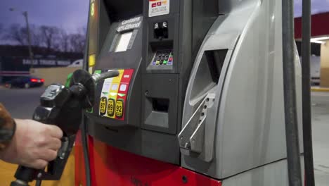 detail shots of filling up with gas at a rural gas station in the early morning light