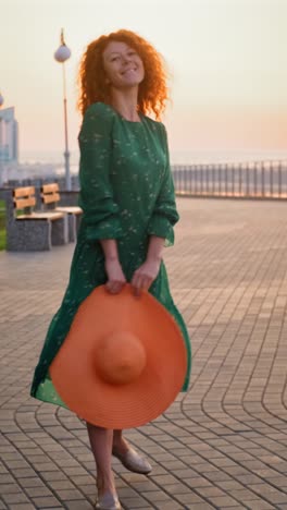 woman in a green dress at sunrise/sunset