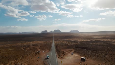 drone view along famous sunny american desert highway road in monuments valley in arizona and utah, forrest gump point in april