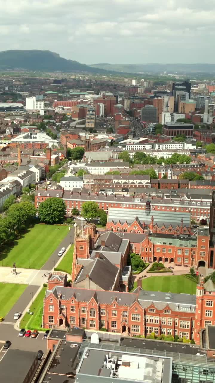 Overhead, side-on reversing social ratio aerial video of Queen's University, Belfast on a bright and sunny day. Filmed in 1080x1920, 60fps and with Rec709 color