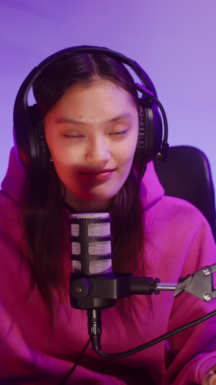 Woman with Microphone and Headphones Recording Podcast